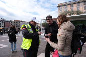 Tourists shows the QR code on a smartphone to prove their payment of a fee for day trippers introduced by Venice