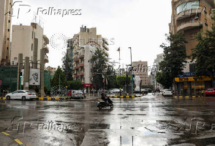 A man rides a motorbike at Sassine Square in Beirut