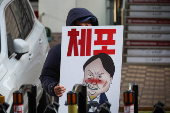 People hold posters ahead of a rally calling for the impeachment of South Korean President Yoon Suk Yeol, in Seoul