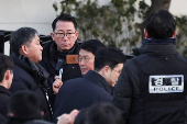 Members of the Corruption Investigation Office for High-ranking Officials gather in front of the impeached South Korean President Yoon Suk Yeol's official residence