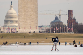 People skate on the ice-covered Lincoln Memorial Reflecting Pool on the National Mall, in Washington