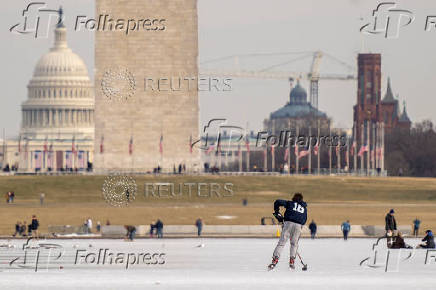 People skate on the ice-covered Lincoln Memorial Reflecting Pool on the National Mall, in Washington