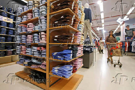 FILE PHOTO: A customer walk inside a clothes store at a shopping mall in Kolkata