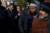 Former members of Syria's Bashar Al Assad's security forces wait to register for the identification and reconciliation process, in Damascus