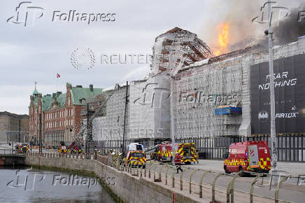 Emergency services work as fire burns at the Old Stock Exchange, Boersen, in Copenhagen