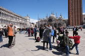 Tourists walk in St Mark's Square on the day Venice municipality introduces a new fee for day trippers