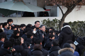 Members of the Corruption Investigation Office for High-ranking Officials gather in front of the impeached South Korean President Yoon Suk Yeol's official residence