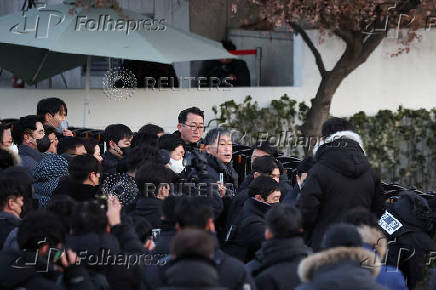 Members of the Corruption Investigation Office for High-ranking Officials gather in front of the impeached South Korean President Yoon Suk Yeol's official residence