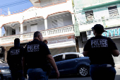 Agents with Homeland Security Investigations (HSI) conduct a search for undocumented migrants in San Juan