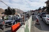 Cars queue to cross into Syria after Syrian rebels announced that they have ousted President Bashar al-Assad, at Masnaa Border Crossing