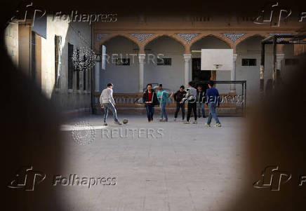 Students in a classroom after authorities announced the reopening of schools, in Damascus