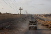 An Israeli military vehicle drives through the Philadelphi Corridor area in southern Gaza