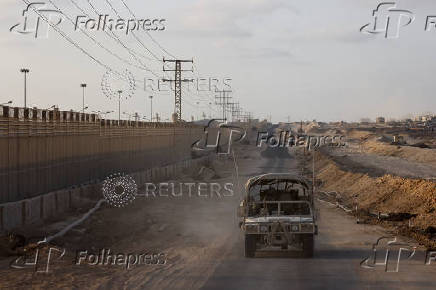 An Israeli military vehicle drives through the Philadelphi Corridor area in southern Gaza