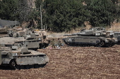 Israeli army soldiers and tanks gather in northern Israel