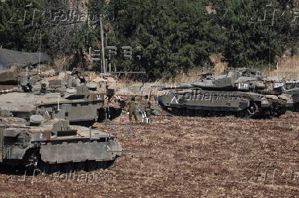 Israeli army soldiers and tanks gather in northern Israel