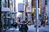 A person waits to cross the road, in New York