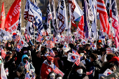 Impeached South Korean President Yoon Suk Yeol's supporters rally near the Corruption Investigation Office for High-ranking Officials, following his arrest, in Gwacheon