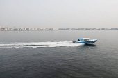 A boat sails across a lagoon near the Lekki-Ikoyi Link Bridge in Lagos