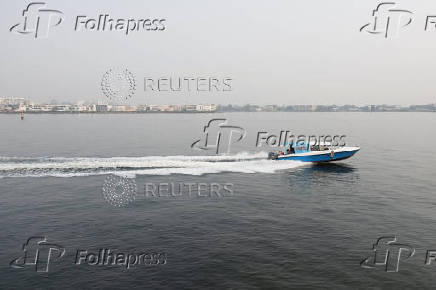 A boat sails across a lagoon near the Lekki-Ikoyi Link Bridge in Lagos