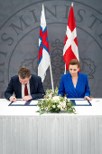 Denmark's Prime Minister Mette Frederiksen and the Faroese Prime Minister Aksel V. Johannesen sign a joint request to the Danish Supreme Court, in Prime Minister's Office, in Copenhagen