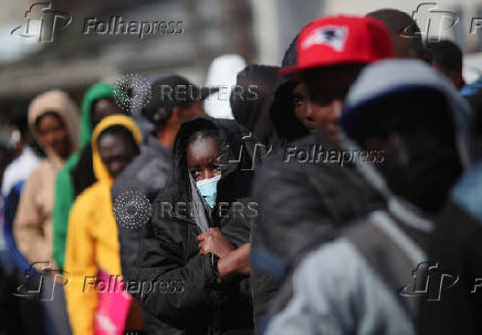 Migrants gather outside of the Mexican Commission for Refugee Assistance (COMAR) in Mexico City