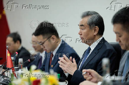 Chinese Foreign Minister Wang Yi gestures during a bilateral meeting with Indonesian Foreign Minister Retno Marsudi in Jakarta