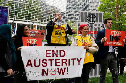 Activists protest outside of the World Bank during the IMF and World Bank's 2024 annual Spring Meetings in Washington