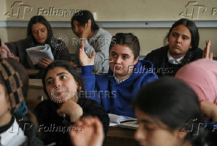 Students attend a class at a school in Qamishli