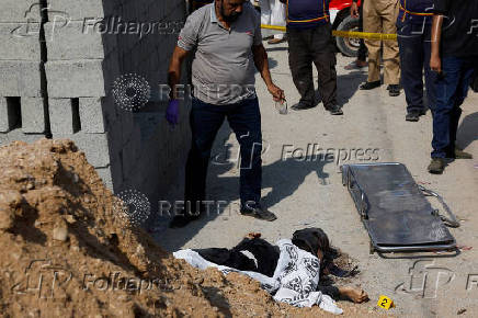 Member of the Crime Scene Unit surveys the site after a suicide blast in Karachi