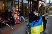 People dressed in traditional clothes sing carols for injured service members in Kyiv