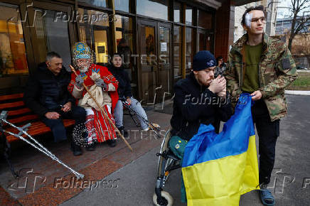 People dressed in traditional clothes sing carols for injured service members in Kyiv