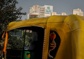 FILE PHOTO: A driver parks an auto-rickshaw in front of an Apollo Hospital building in New Delhi