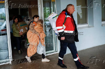 People evacuate hospital after authorities declare possible danger of Russian strike, in Kyiv