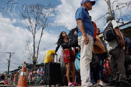 Venezuelans queue to enter a shelter after leaving Venezuela, in Pacaraima