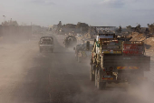 Israeli military vehicles drive through the Philadelphi Corridor area in southern Gaza