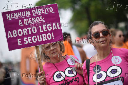 Demonstrators attend a walk, aimed to call for an end of violence against girls and women, in Copacabana beach in Rio de Janeiro