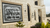 Palestinians check damage to a mosque burned by Israeli settlers in the West Bank