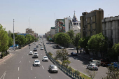 Cars pass on a street in Tehran