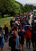 Migrants walk in a caravan in an attempt to reach the U.S. border, in Huixtla