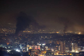 Smoke billows over Beirut's southern suburbs, as seen from Sin El Fil