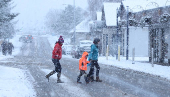 Pedestrians cross the road in Aviemore, Scotland