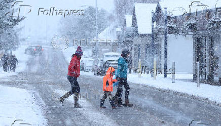 Pedestrians cross the road in Aviemore, Scotland