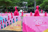 People dressed as guards from the Netflix series Squid Game attend an event at the Gelora Bung Karno Stadium ahead of the release of the Netflix series Squid Game: Season 2 in Jakarta