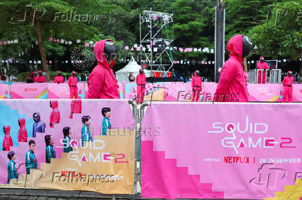 People dressed as guards from the Netflix series Squid Game attend an event at the Gelora Bung Karno Stadium ahead of the release of the Netflix series Squid Game: Season 2 in Jakarta