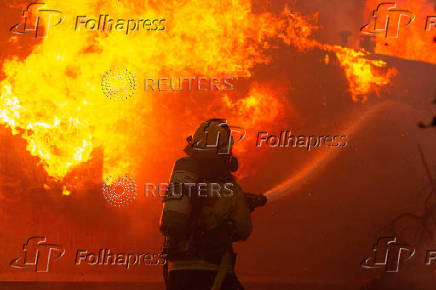 Palisades Fire burns during a windstorm on the west side of Los Angeles