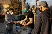 Volunteers with World Central Kitchen hand out free food to residents affected by the Eaton Fire in Altadena