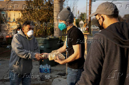 Volunteers with World Central Kitchen hand out free food to residents affected by the Eaton Fire in Altadena