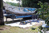 The boat in which decomposed bodies were found by fishermen, rests next to belongings removed from it, at the Para Scientific Police headquarters in Braganca,