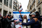 Pro-Israeli counter-protesters arrive in front of the building of the Sciences Po University where people protesting in support of Palestinians in Gaza take part in the occupation of a street, in Paris