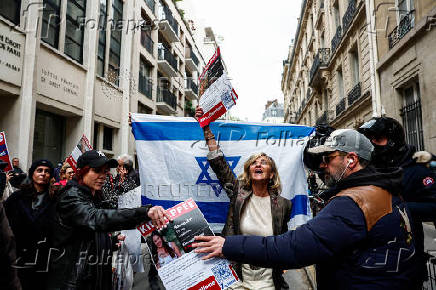 Pro-Israeli counter-protesters arrive in front of the building of the Sciences Po University where people protesting in support of Palestinians in Gaza take part in the occupation of a street, in Paris